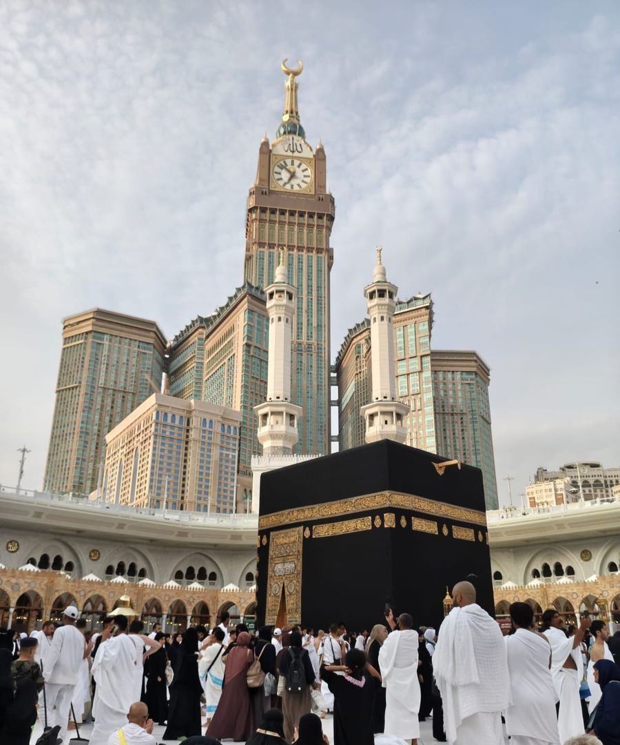 The Kaaba with the Makkah Clock Tower and minarets of Masjid al Haram behind it